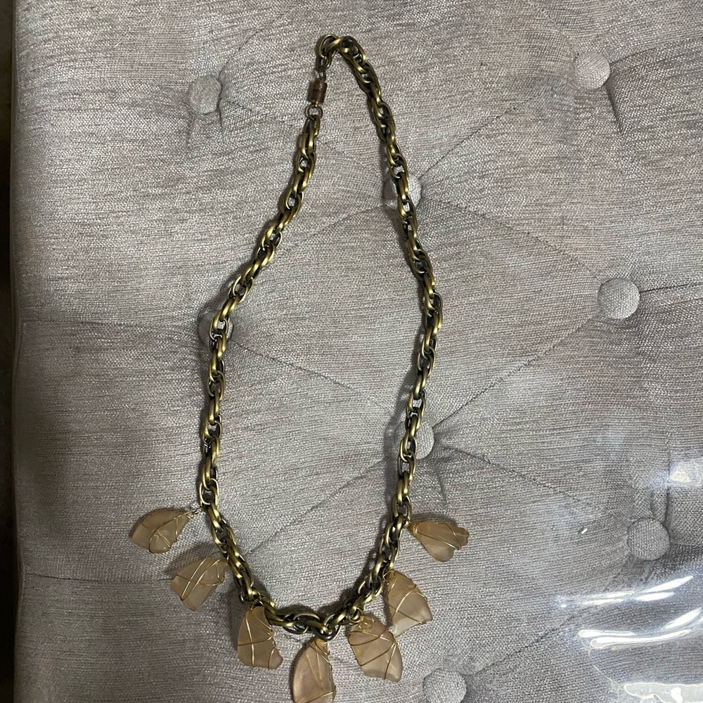 Gold tone necklace with wrapped gold tone wire around pale pink beach glass